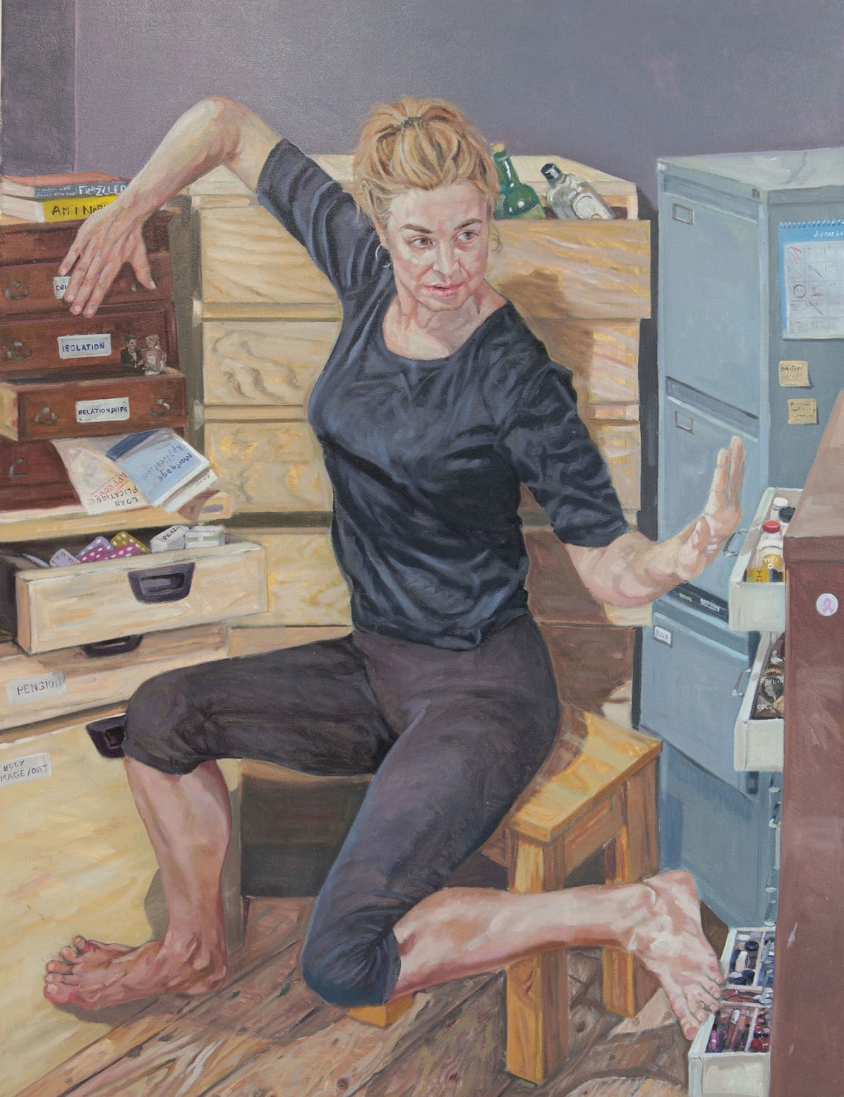 Woman sitting on a stool in a cluttered room with drawers and a filing cabinets.